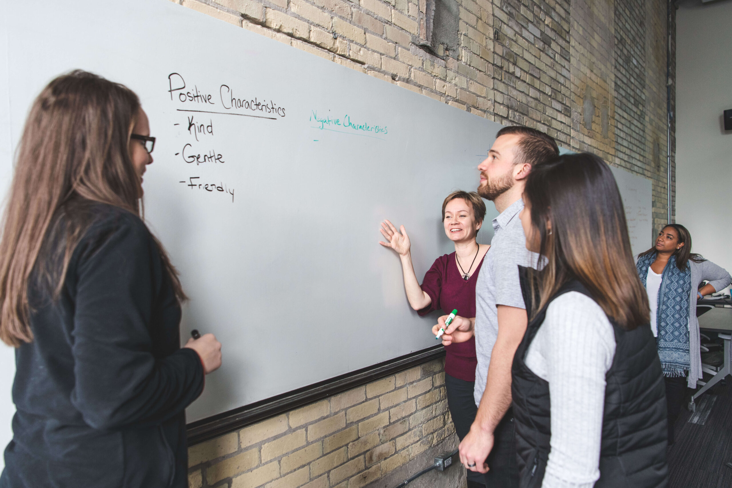 group-of-people-in-training-course-discussing-idea-at-whiteboard
